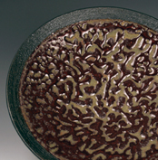 18. Detail: Thrown dish with black rounded base & coral-brain purple glaze.