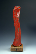 9. Assembled and carved and curved obelisk with red crawling stoneware glaze mounted on oak base