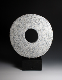37. White ground disc on stone base, 50cm high 