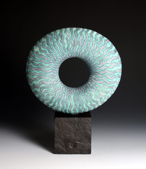 Disc form on stone base, 23 cm diameter