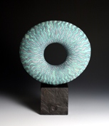 39. Disc form on stone base, 23 cm diameter