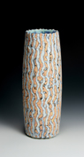 24. Tall ground vessel with yellow, orange, red, black and white pattern