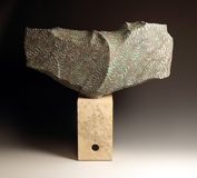 46. Grey/green large cut form on travertine stone base, 62cm high