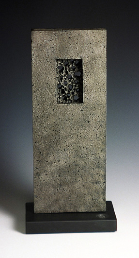Cast iron form on stone base, 25cm high