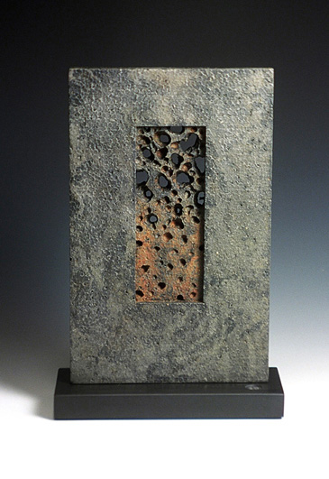 Cast iron form on stone base, 29cm high