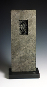25. Cast iron form on stone base, 25cm high
